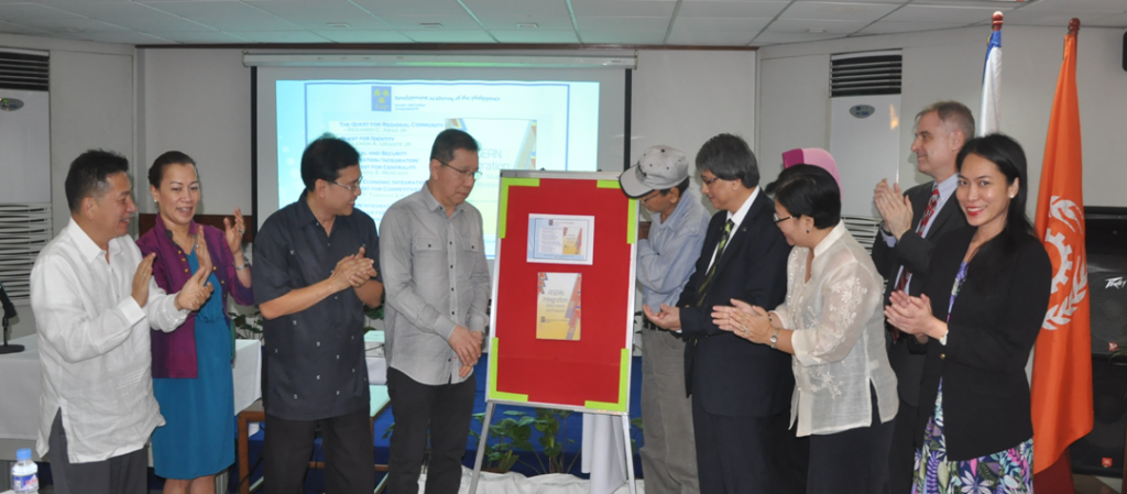 Eminent Fellow Dr. Orly Mercado and Prof. Jose Tabbada (fourth and fifth from left), co-authors of the book ASEAN Integration: Status, Issues, and Prospects along with Executive Fellow Carlos Tabunda Jr. (third from left), look at the cover of the book after it was unveiled during its launching ceremonies.   Also in picture are (from right) Lisa Makinano, Neil Philipps, Foreign Affairs Assistant Secretary Hellen de la Vega, President Tony Kalaw, Ma. Anthonette Allones and Arthur Luis Florentine. 